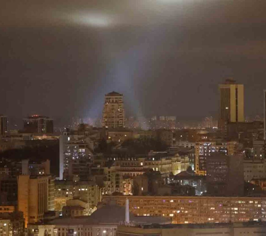 Ukrainian service personnel use searchlights as they search for drones in the sky over the city during a Russian drone strike, amid Russia's attack on Ukraine, in Kyiv, Ukraine.