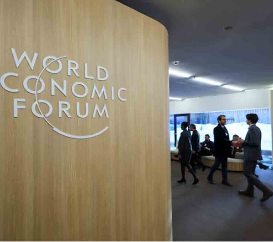 People walk next to the logo of World Economic Forum (WEF) on the first day of the annual meeting in Davos, Switzerland,.