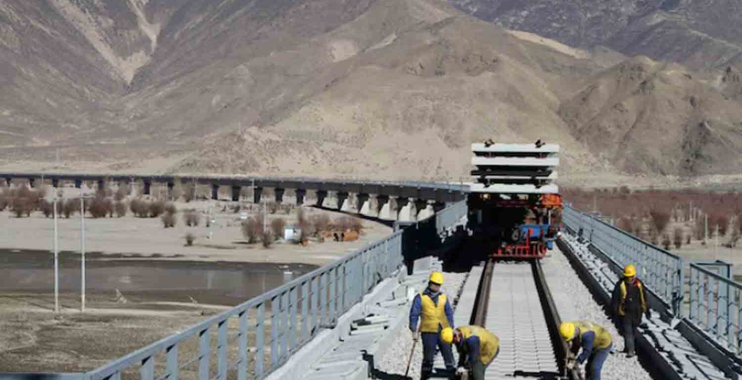 Workers are seen on railway tracks at a bridge over Yarlung Tsangpo river as they work on the construction of the railroad linking Lhasa and Nyingchi, in Tibet Autonomous Region, China.