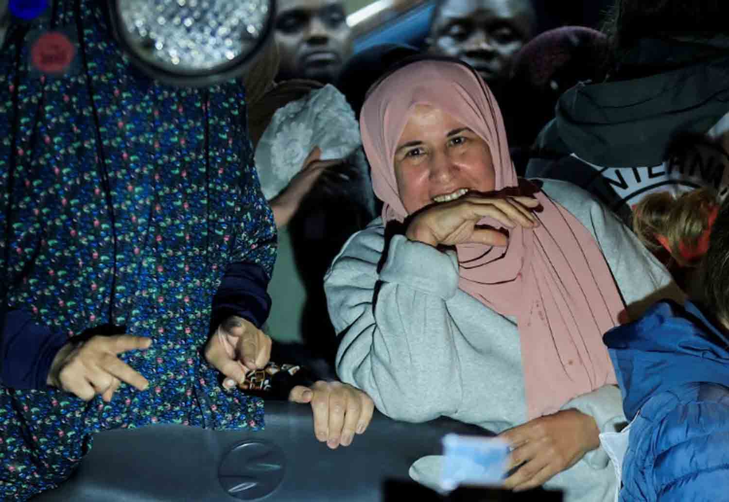 A freed Palestinian prisoner reacts from inside a bus that arrived with them after their release from an Israeli jail as part of a hostages-prisoners swap and a ceasefire deal in Gaza between Hamas and Israel, in Ramallah, in the Israeli-occupied West Bank.