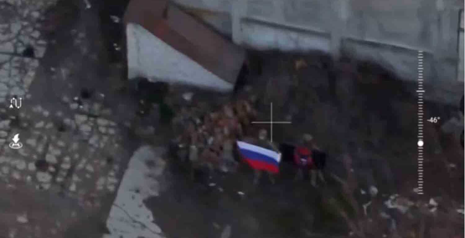 A soldier holds up a Russian flag in Kurakhove, Donetsk Region, Ukraine in this screen grab taken from a social media video released on January 5, 2025.