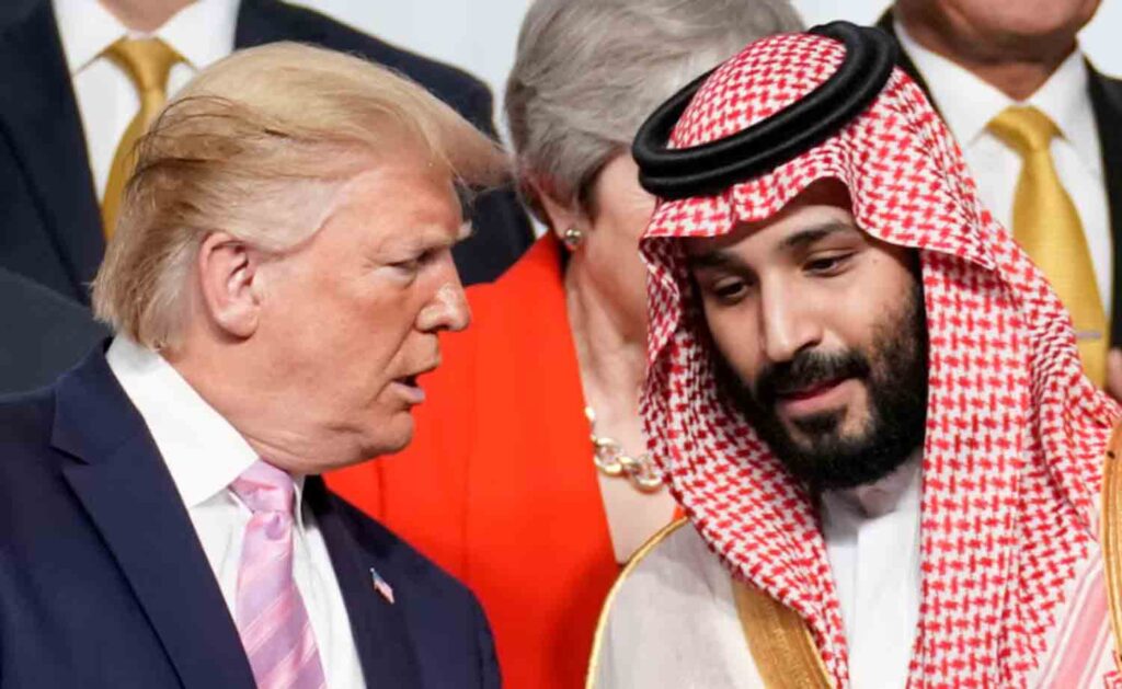 U.S. President Donald Trump speaks with Saudi Arabia's Crown Prince Mohammed bin Salman during family photo session with other leaders and attendees at the G20 leaders summit in Osaka, Japan.