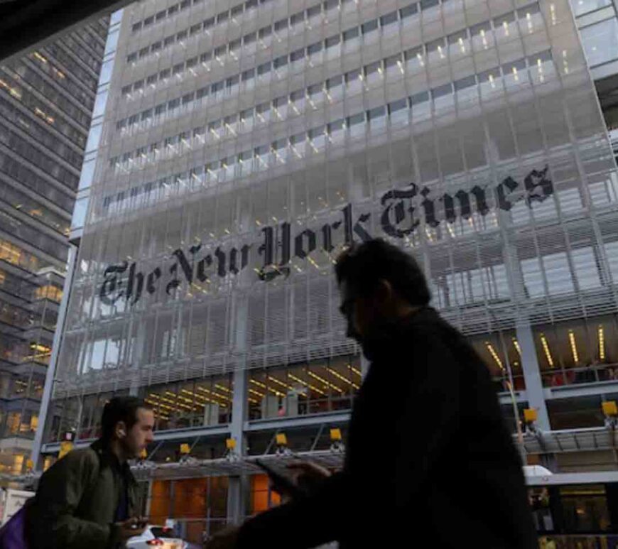 Pedestrians walk by the New York Times building in Manhattan, New York, U.S.