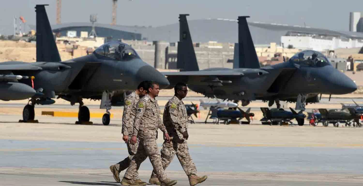 Saudi army officers walk past F-15 fighter jets, GBU bombs and missiles displayed during a ceremony marking the 50th anniversary of the creation of the King Faisal Air Academy at King Salman airbase in Riyadh.