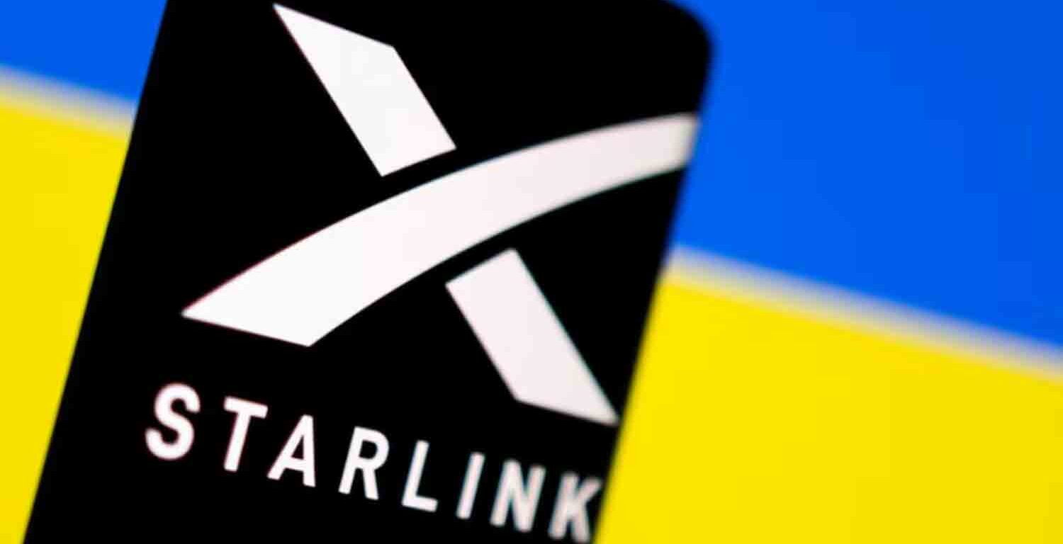 Starlink logo is seen on a smartphone in front of displayed Ukrainian flag in this illustration.