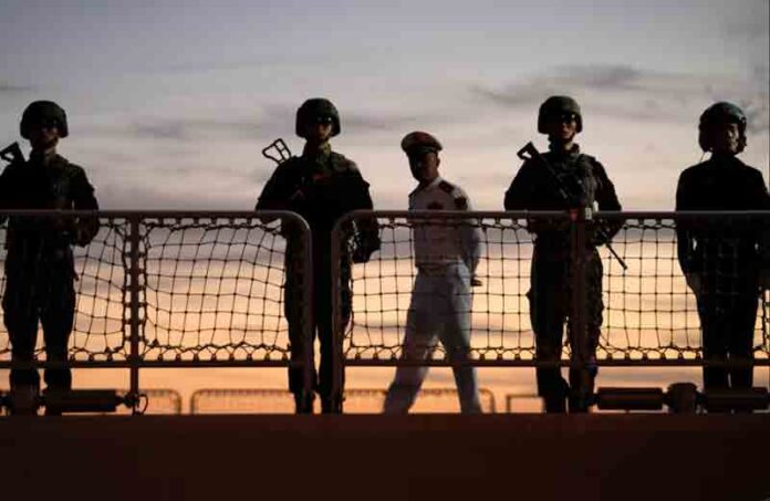Chinese navy troops attending a joint naval drill with Iran and Russia stand on the deck of their warship in an official arrival ceremony at Shahid Beheshti port in Chabahar in the Gulf of Oman, Iran.