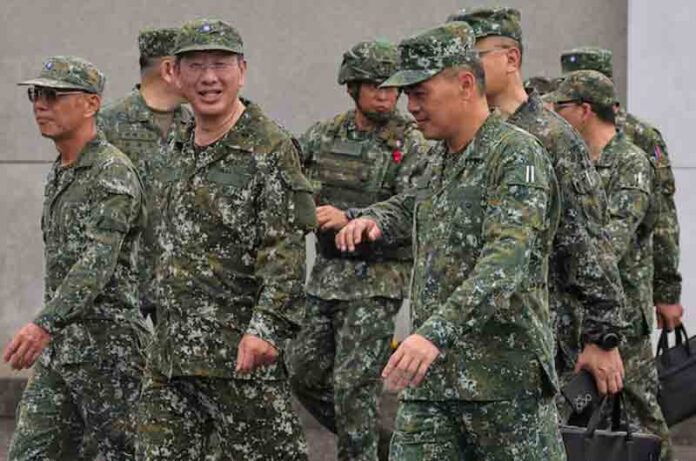 Defence Minister Wellington Koo inspects troops during a live fire exercise at the Fangshan training grounds in Pingtung, Taiwan.