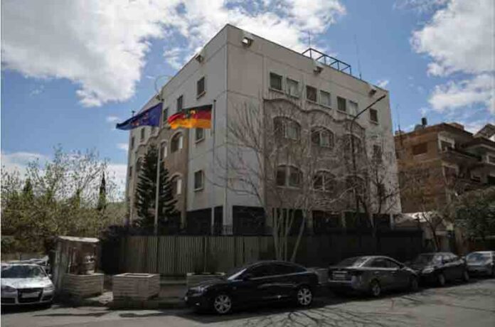 A German and a European Union flags flutter at the German embassy, after it was reopened in Damascus, Syria.