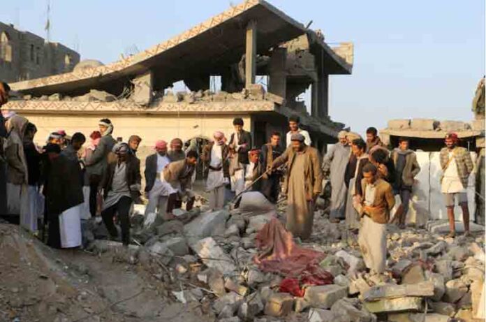 People gather on the rubble of a house hit by a U.S. strike in Saada, Yemen