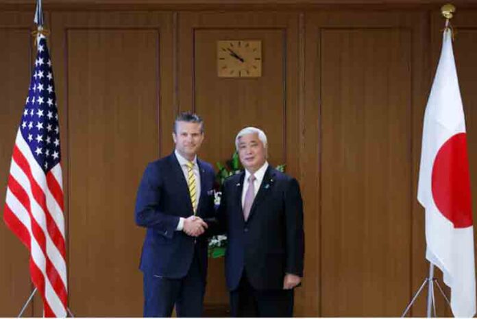 Pete Hegseth, US secretary of defense, and Gen Nakatani, Japan's defense minister, shake hands while posing for photographs prior to their meeting at the Ministry of Defense in Tokyo, Japan.