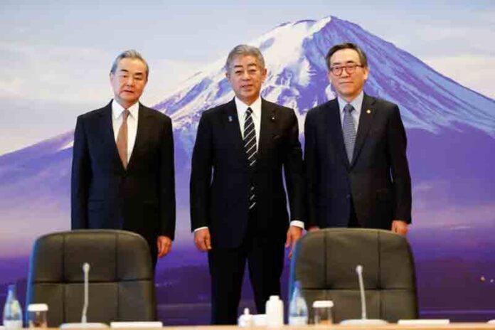 Chinese Foreign Minister Wang Yi, Japanese Foreign Minister Takeshi Iwaya and South Korean Foreign Minister Cho Tae-yul pose for the cameras during the 11th Trilateral Foreign Minister’s Meeting (Japan-China-ROK) in Tokyo