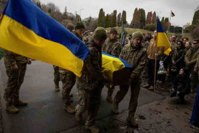 Ukrainian servicemen carry the coffin of the Hospitallers Medical Battalion volunteer and soldier Oleksandr 'Bohush' Oliynyk at a cemetery, amid Russia's attack on Ukraine, in Kyiv, Ukraine.