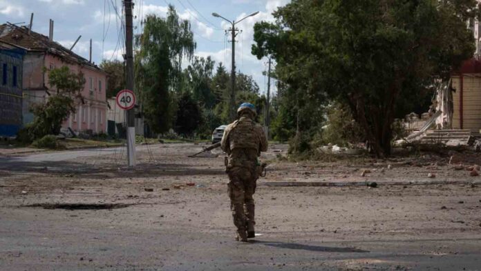 A Ukrainian soldier walks past Sudzha's city center in Kursk region, Russia.