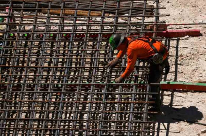 Workers install steel rods at a construction site in Miami, Florida, U.S.