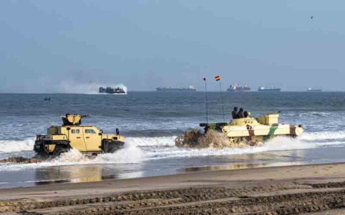 Indian Army soldiers from the 4/8 Gurkha Rifles Infantry Battalion, 91st Infantry Brigade, maneuver in a Mahindra Armored Light Specialist Vehicle alongside a BMP-II Sarath amphibious infantry combat vehicle during a large-scale amphibious landing drill conducted as part of Exercise Tiger Triumph at Kakinada Beach, Andhra Pradesh, India, on April 11, 2025.