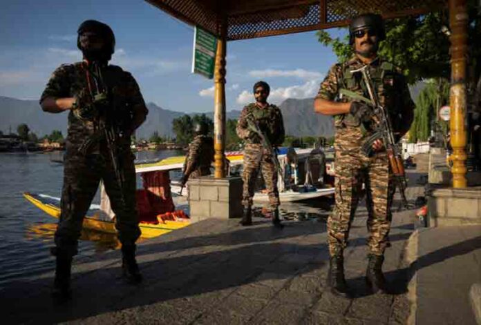 Indian-army-in-Kashmir Indian security force personnel stand guard on the banks of Dal Lake, following a suspected militant attack near south Kashmir's Pahalgam, in Srinagar.