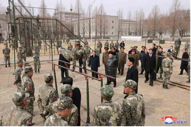 North-Korean-leader-Kim-Jong-Un-watches-a-cadet-practicing-on-the-parallel-bars North Korean leader Kim Jong Un watches a cadet practicing on the parallel bars during his visit to the Kang Kon Military Academy, in Pyongyang, North Korea.