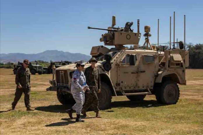 Philippine-and-U.S.-soldiers-walk-past-a-MADIS-or-Marine-Air-Defense-Integrated-System Philippine and U.S. soldiers walk past a MADIS or Marine Air Defense Integrated System during the annual joint military exercises between the U.S. and Philippine troops called "Balikatan" or shoulder-to-shoulder, at a naval base in San Antonio, Zambales province, Philippines.
