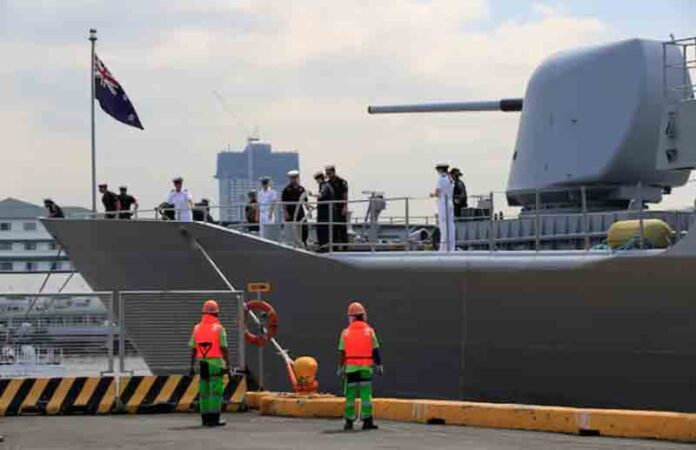 Crew members of the Royal New Zealand Navy frigate HMNZS Te Kaha (F77) prepare to dock upon arrival at the South Harbor, for a four-day goodwill visit in metro Manila, Philippines.