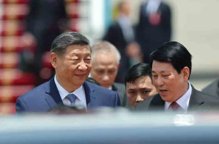 Chinese President Xi Jinping speaks with Vietnam's President Luong Cuong, as he arrives for a two-day state visit, at Hanoi's Noi Bai International Airport, Vietnam.