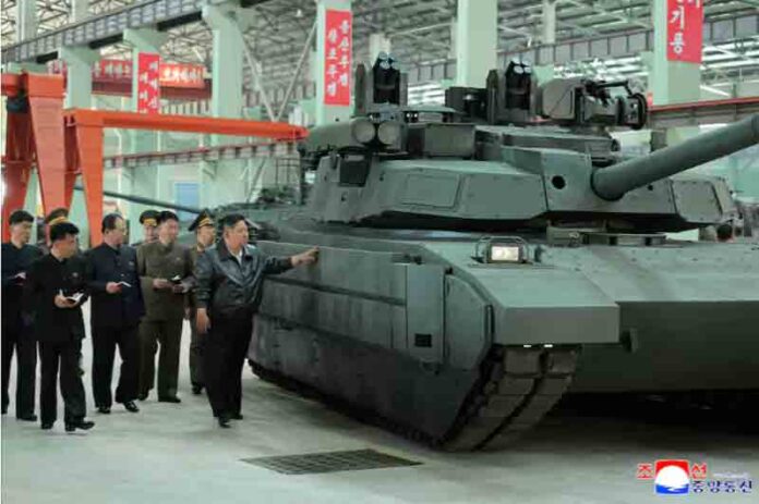 Kim-Jong-Un-touches-tank-armour-as-he-tours-a-military-equipment-facility North Korea's leader Kim Jong Un touches tank armour as he tours a military equipment facility at an unspecified location in North Korea.