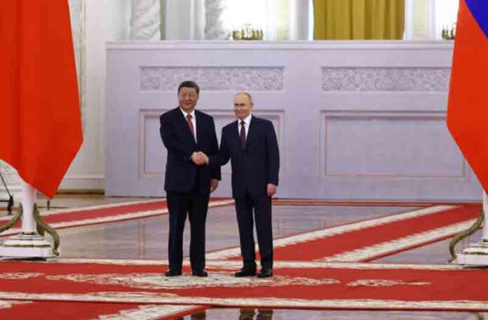 Vladimir-Putin-shakes-hands-with-Xi-Jinping Russian President Vladimir Putin shakes hands with his Chinese counterpart Xi Jinping during a welcoming ceremony before their talks at the Kremlin in Moscow, Russia.