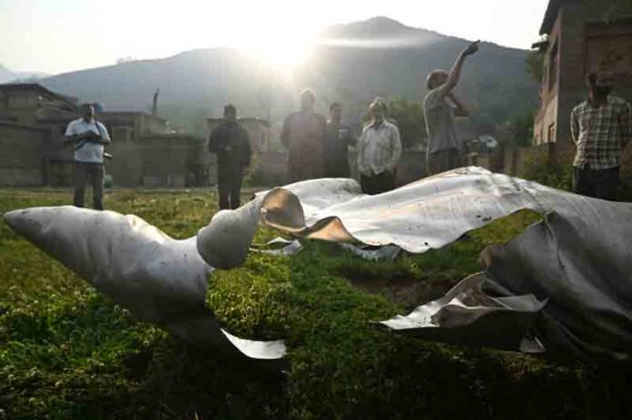 indian-fighter-jet-debris People look at a part of an aircraft in Wuyan, Indian-administered Kashmir.