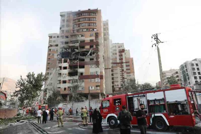 damaged-building-in-the-aftermath-of-Israeli-strikes Firefighters work at the scene of a damaged building in the aftermath of Israeli strikes, in Tehran