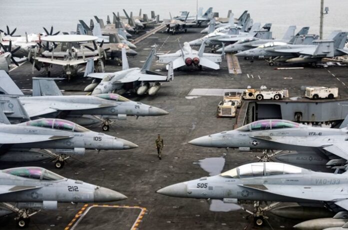 Aircraft carrier USS Abraham Lincoln and its strike group, including destroyers, F-35s