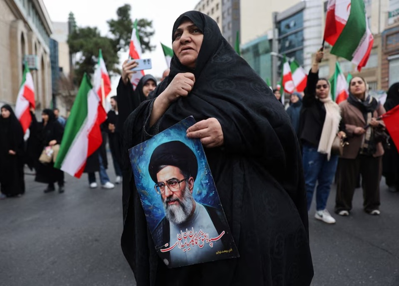 A woman holds an image of Iran's Supreme Leader Ayatollah Ali Khamenei as Iranian demonstrators protest against the U.S.-Israeli strikes, in Tehran, Iran, February 28, 2026.