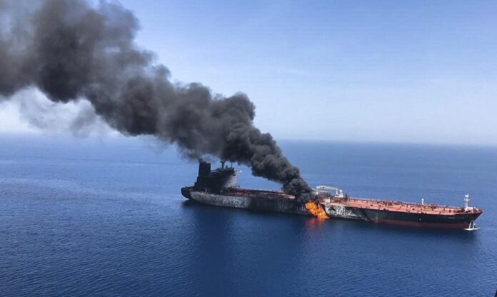 An oil tanker on fire in the Gulf of Oman.