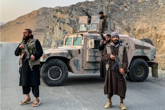 Taliban security personnel stand guard near the Torkham border crossing between Afghanistan and Pakistan in the Nangarhar province.