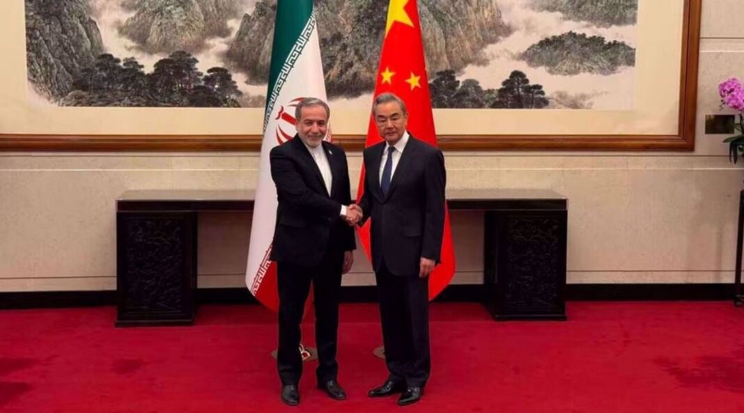 Iran’s Foreign Minister Abbas Araghchi (L) shakes hand with his Chinese counterpart, Wang Yi, in Beijing, China, May 5, 2026.