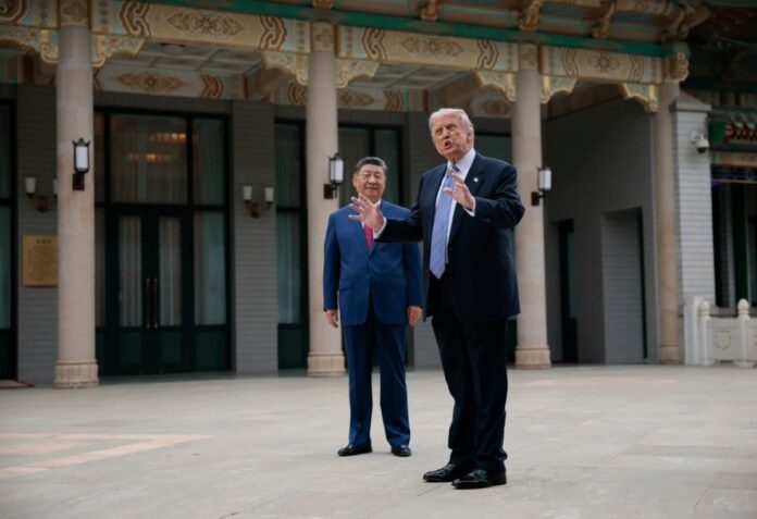 U.S. President Donald Trump gestures as he speaks next to Chinese President Xi Jinping at the Zhongnanhai Garden on Friday. Issues including Taiwan, Iran and others were dicussed.