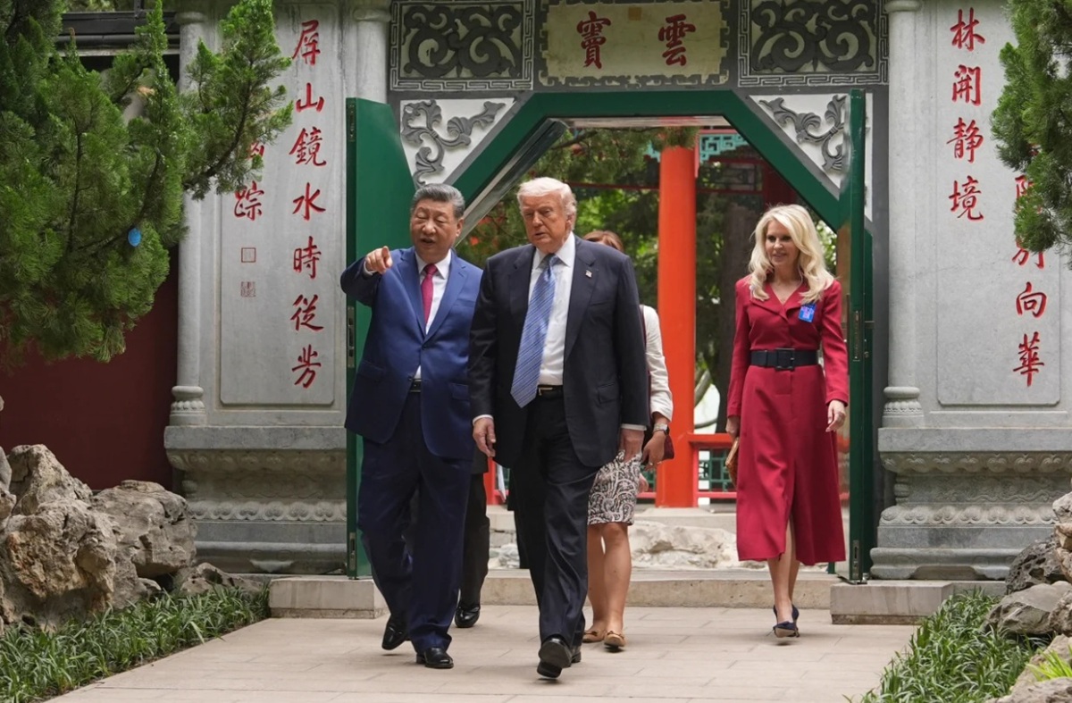 US President Donald Trump walks with China's President Xi Jinping at the Zhongnanhai leadership compound in Beijing on Friday.